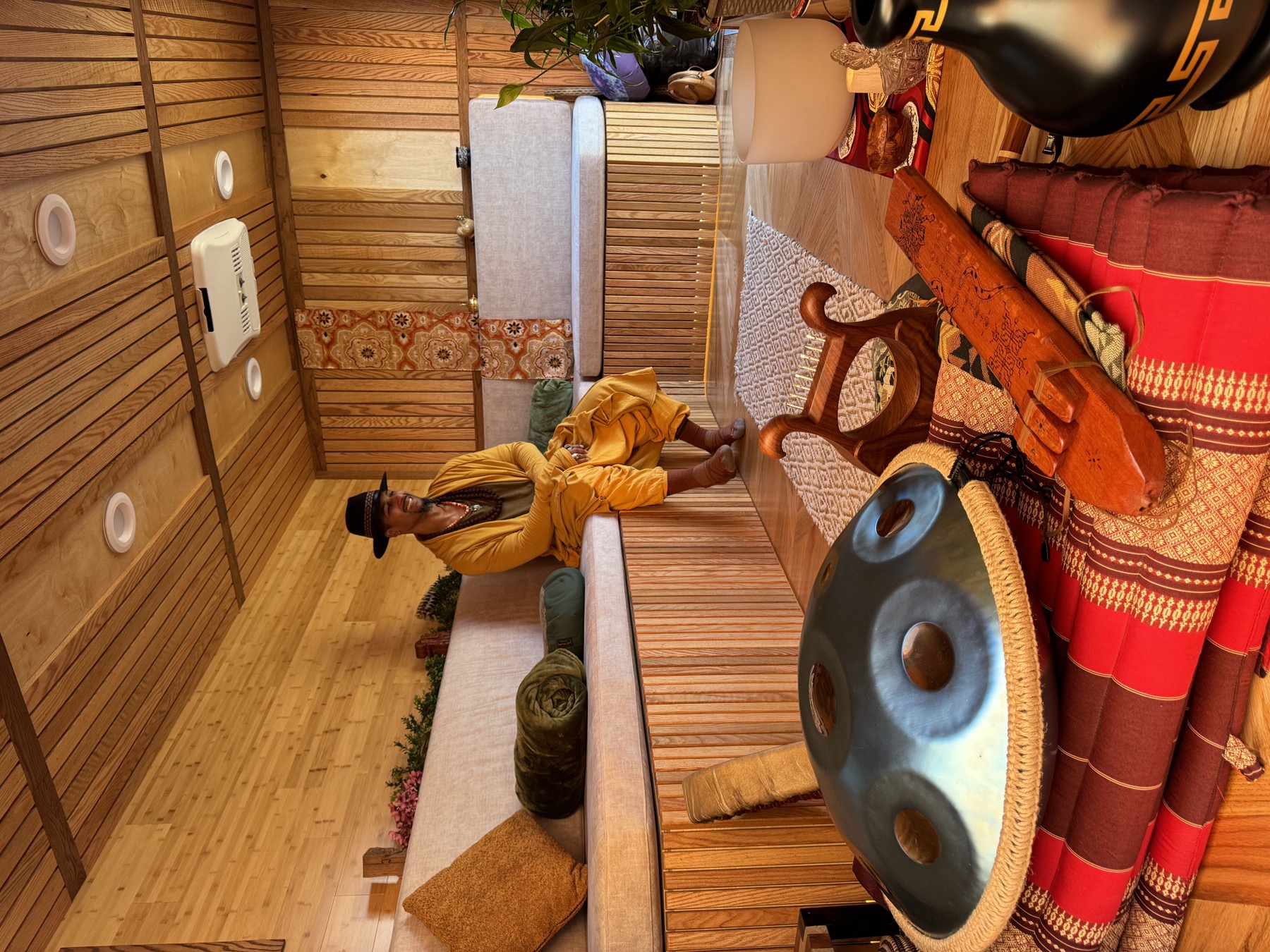 The Saltuary’s warm wood interior with cushioned seating, a handpan, and sound instruments